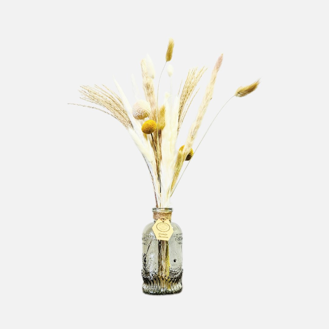 Dried flowers in a Jean bottle