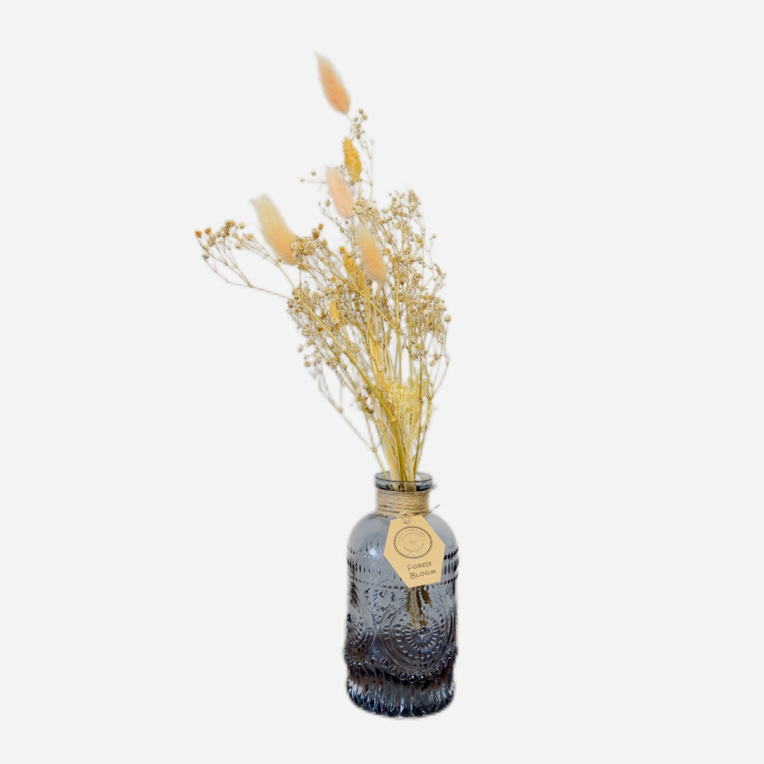 Dried flowers in a Roy bottle